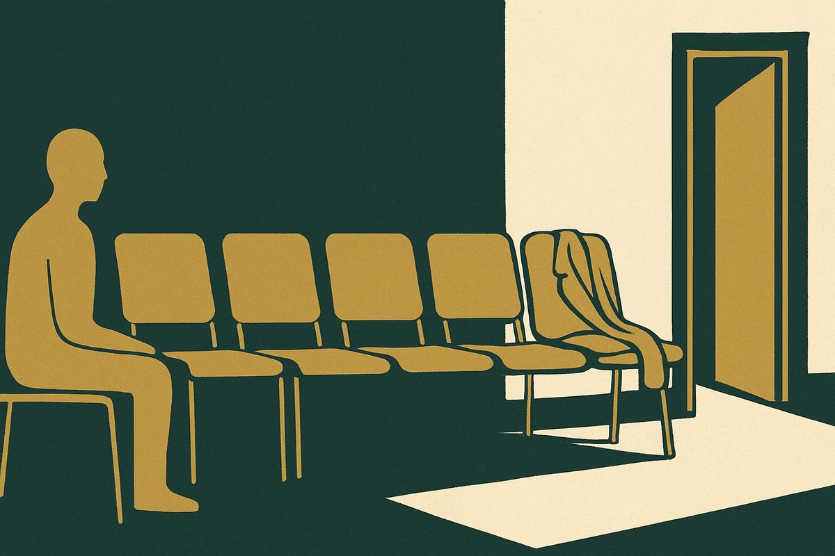 A row of empty waiting-room chairs along a corridor wall.